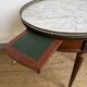 Louis XVI style bouillotte table in mahogany, white marble, and brass.