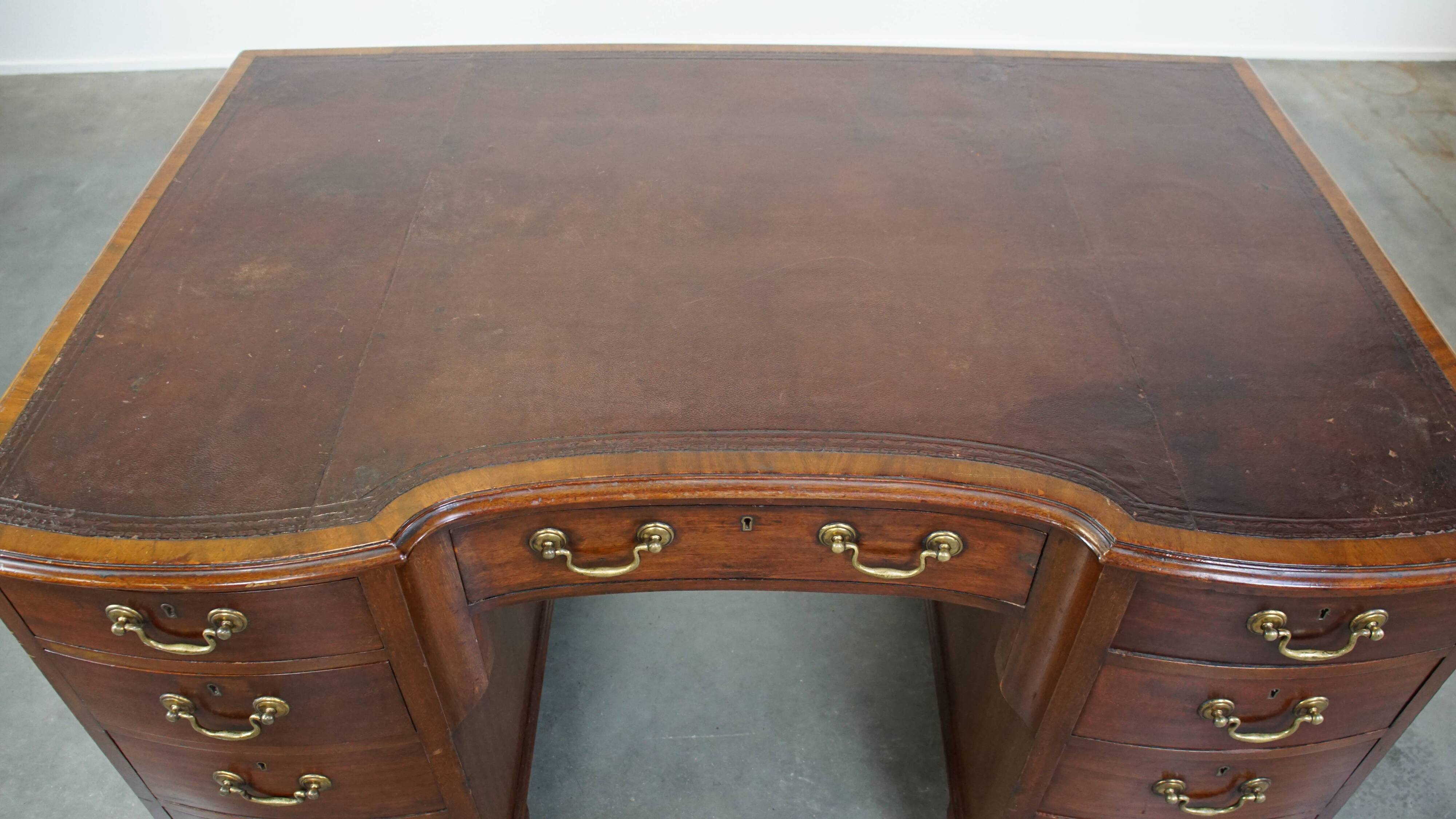 Antique wooden English desk from the late 19th century with a leather top
