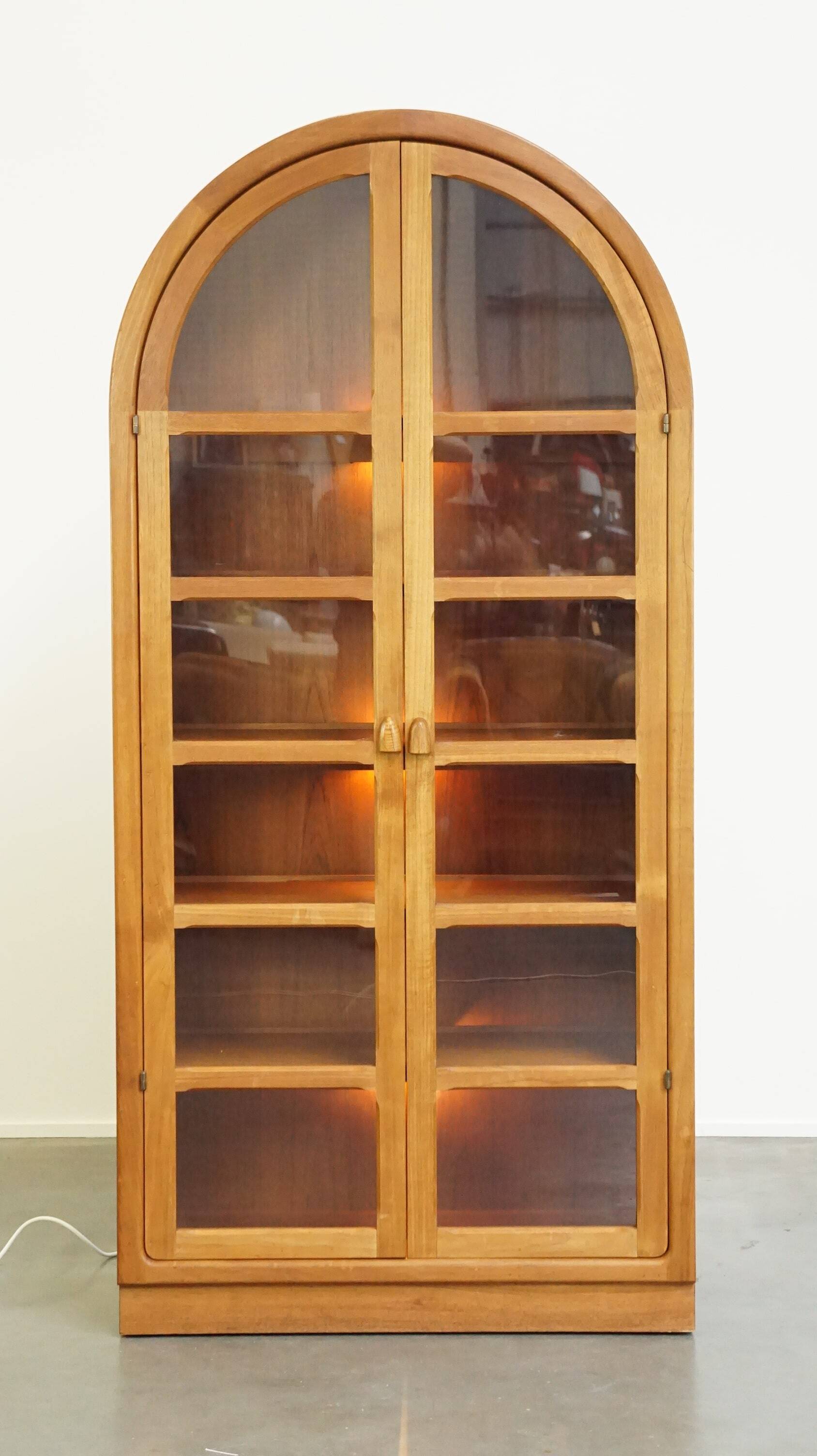 Elegant vintage Danish display cabinet with glass panels and atmospheric lighting