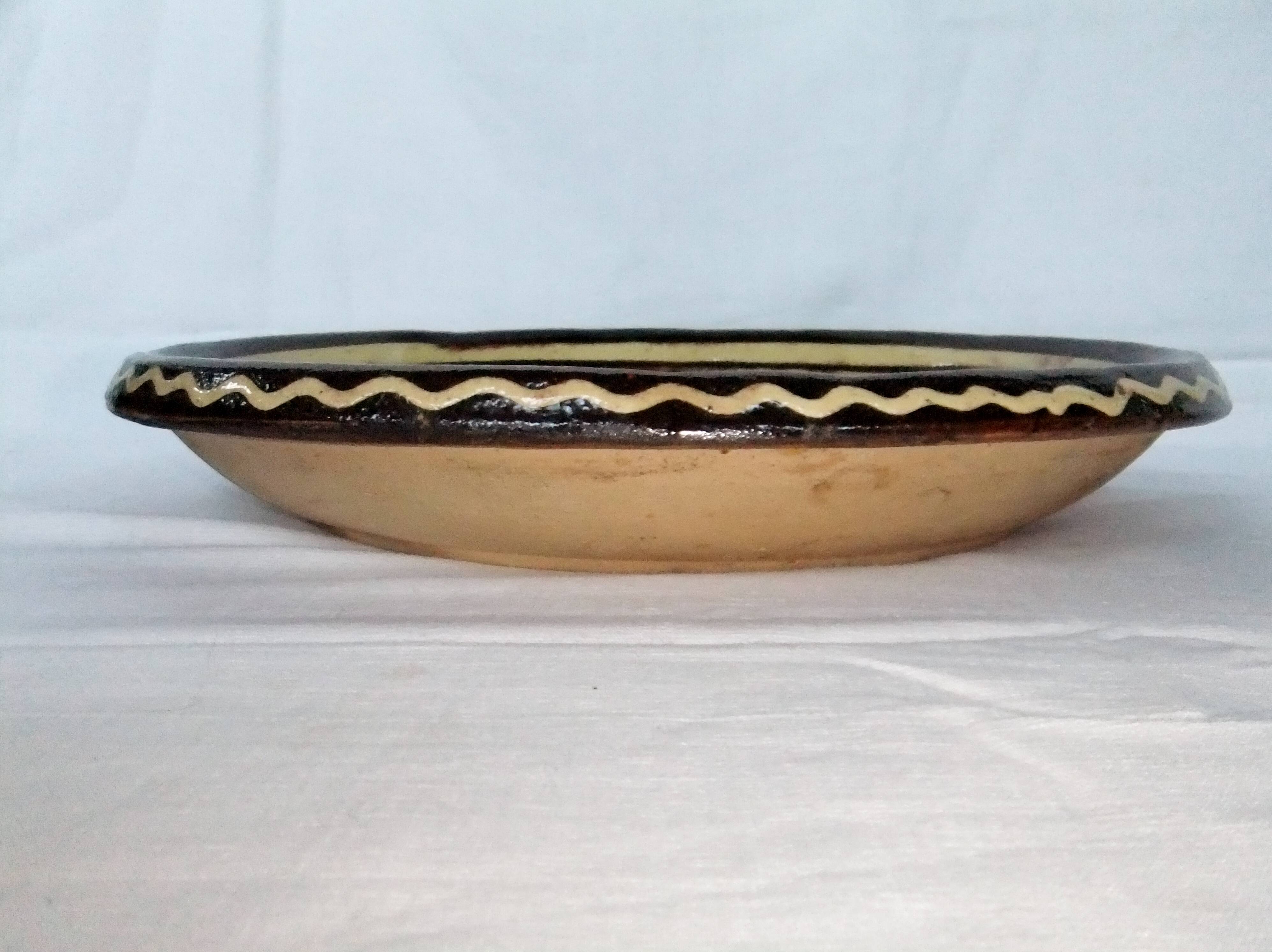 old terracotta dish decorated with rooster