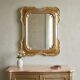 Antique mirror with a gilded frame and floral decorations, Italy, 20th century.