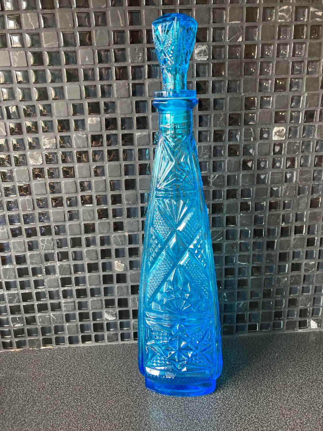 Blue chiseled glass bottle
