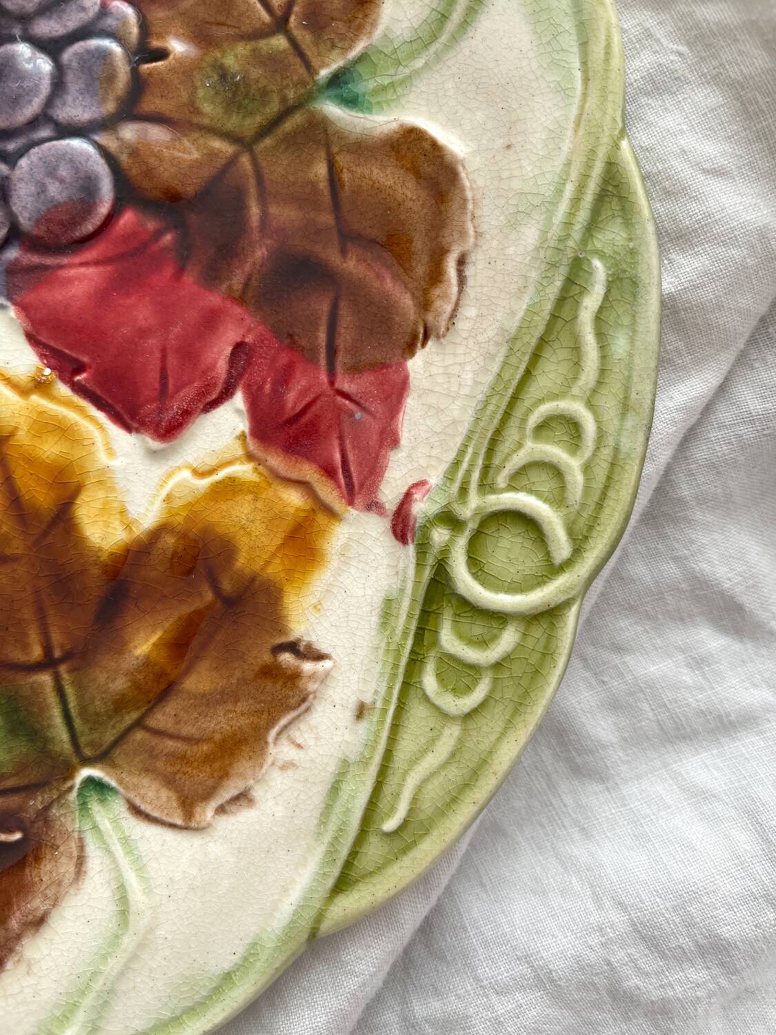 Antique plate in barbotine grapes and vine leaves from Orchies