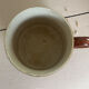 Vintage 70s old ceramic mug with a brown cubic graphic pattern.