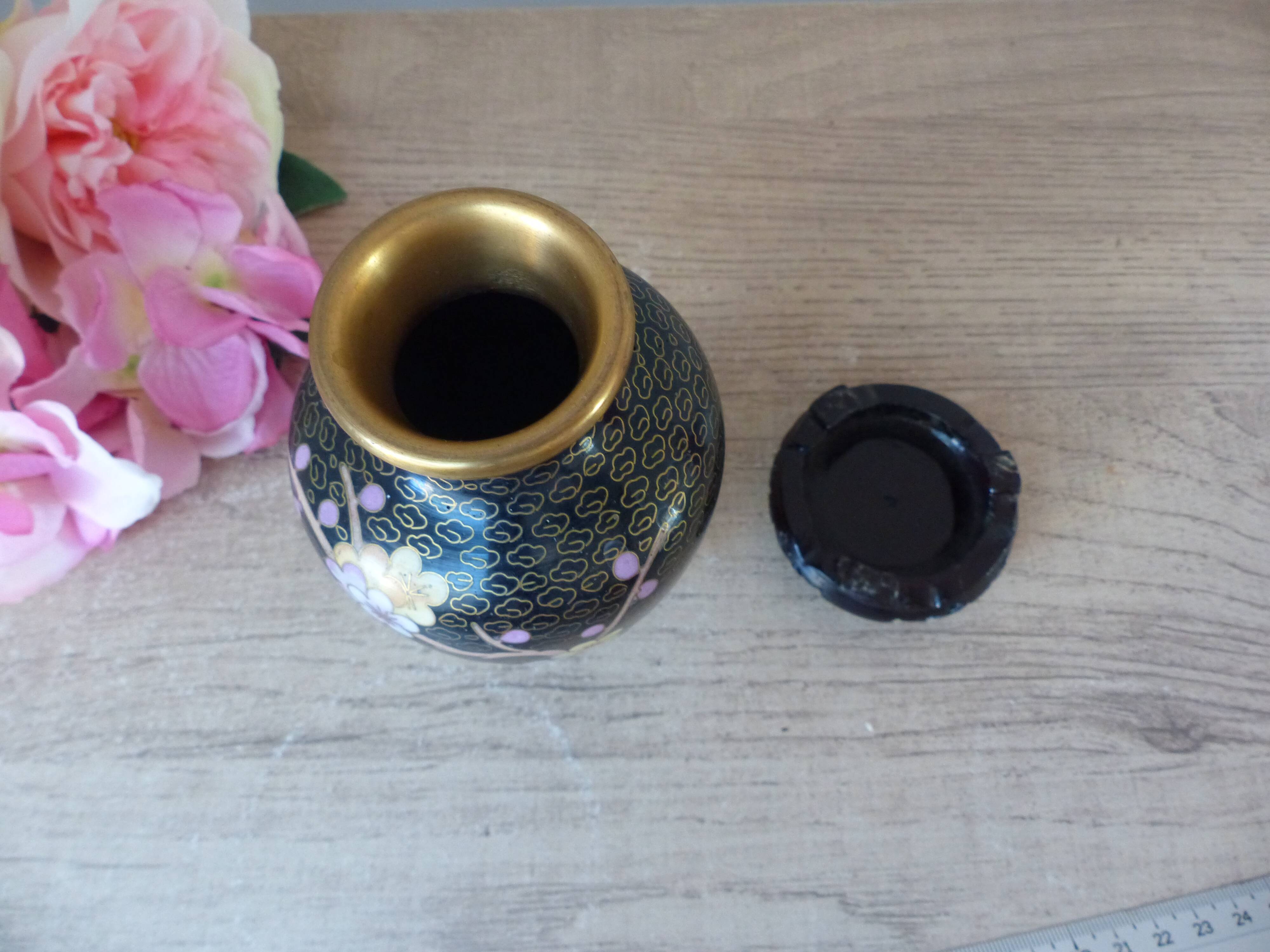 Small black cloisonné vase decorated with yellow and pink cherry blossoms, vase on wooden base