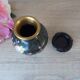 Small black cloisonné vase decorated with yellow and pink cherry blossoms, vase on wooden base