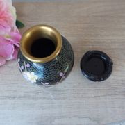 Small black cloisonné vase decorated with yellow and pink cherry blossoms, vase on wooden base