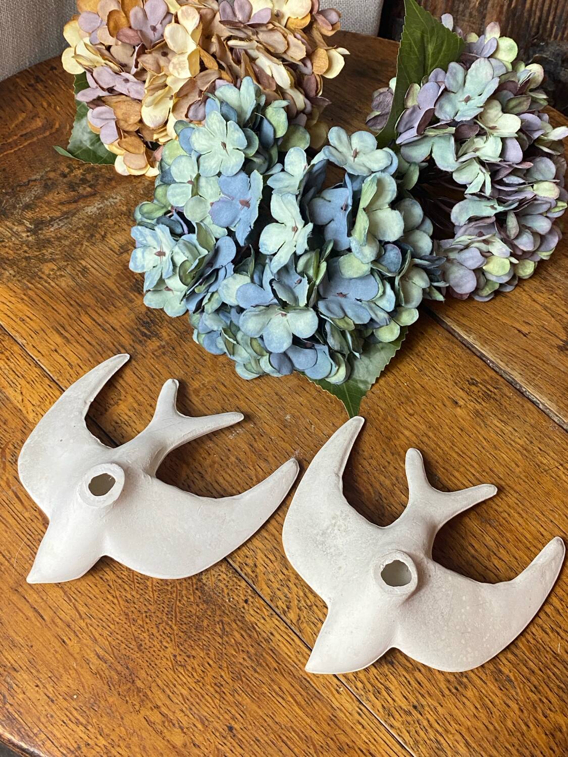 Pair of plaster swallows