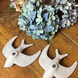 Pair of plaster swallows