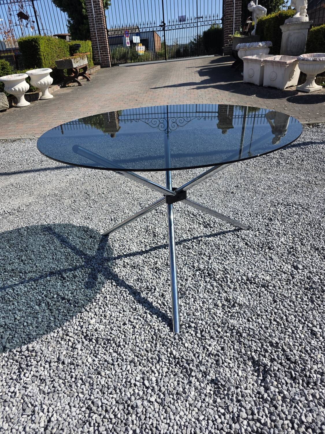 Round chrome metal table with smoked glass top from the 70s