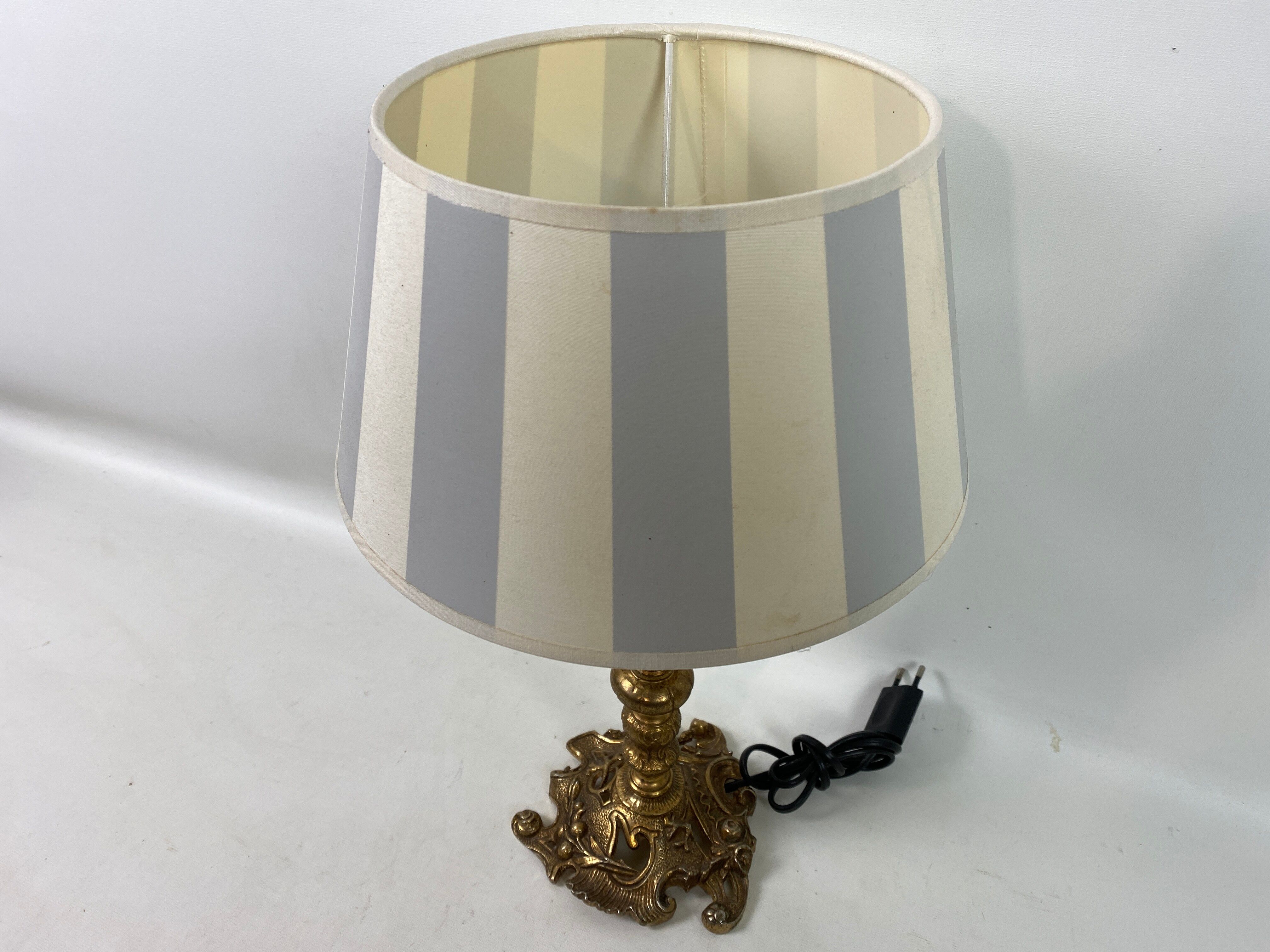 Lamp to lay brass feet offal white and gray day