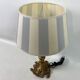 Lamp to lay brass feet offal white and gray day