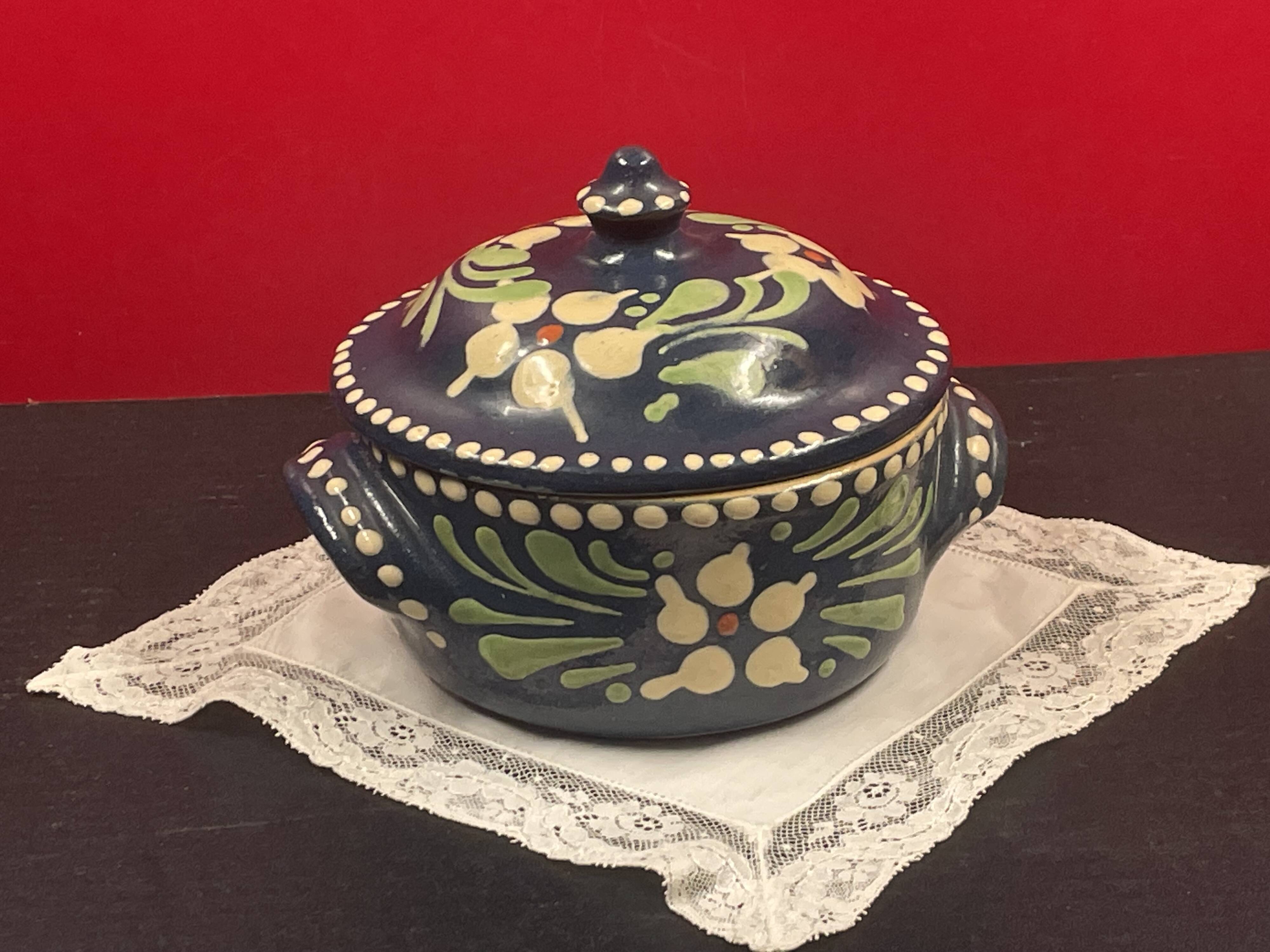 Small covered terracotta pot enamelled savoie or alsace flowers on a blue background