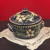 Small covered terracotta pot enamelled savoie or alsace flowers on a blue background