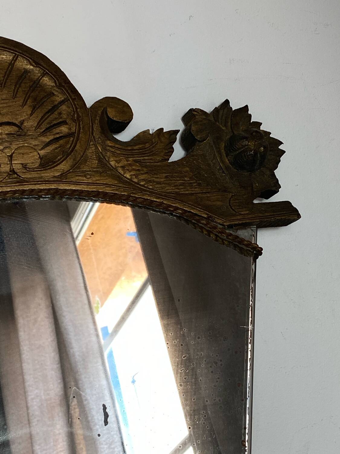 Antique wooden mirror with an unusual shape