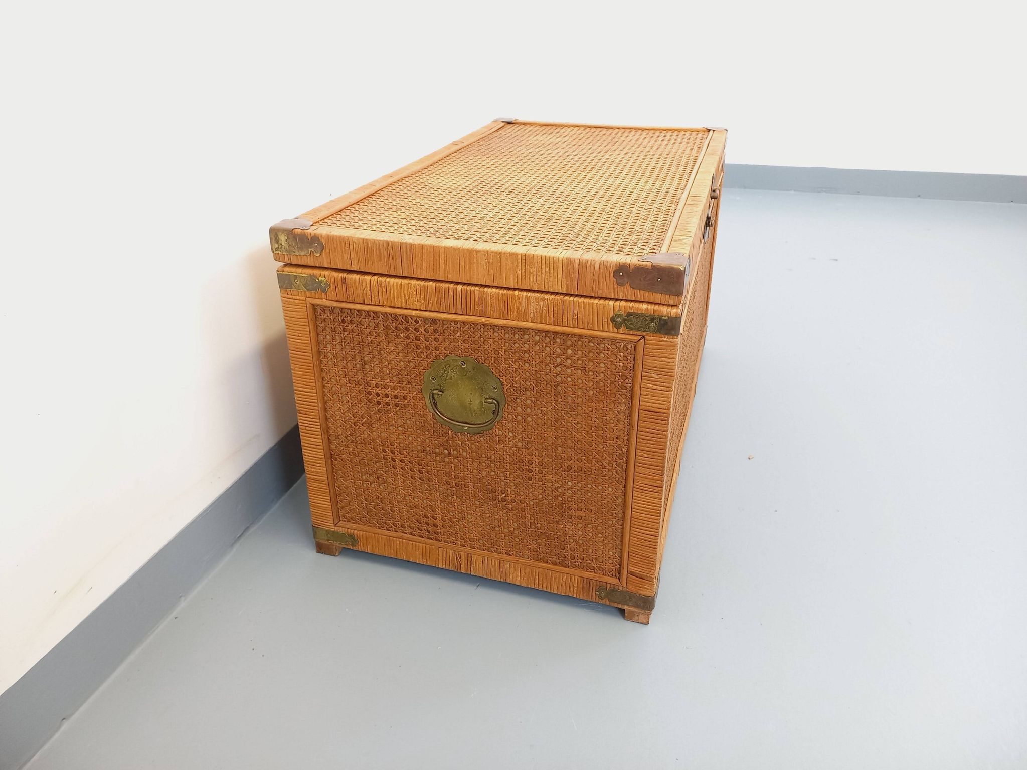 Vintage trunk in wood, rattan, caning, and brass.
