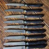 A set of 10 small knives with black wooden handles