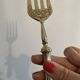 Engraved meat fork in silver and gold metal
