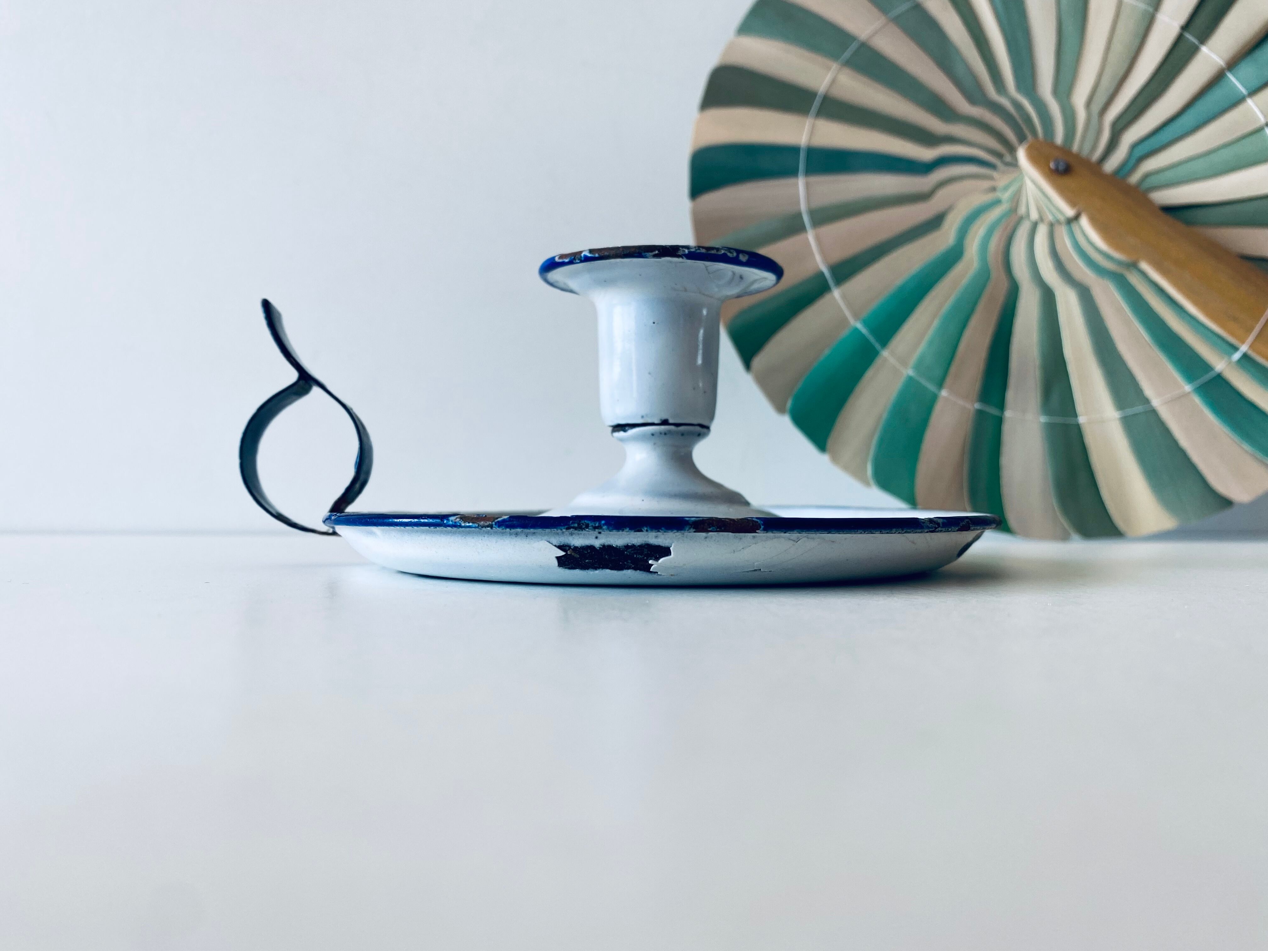 Antique candle holder in white and blue enamelled metal