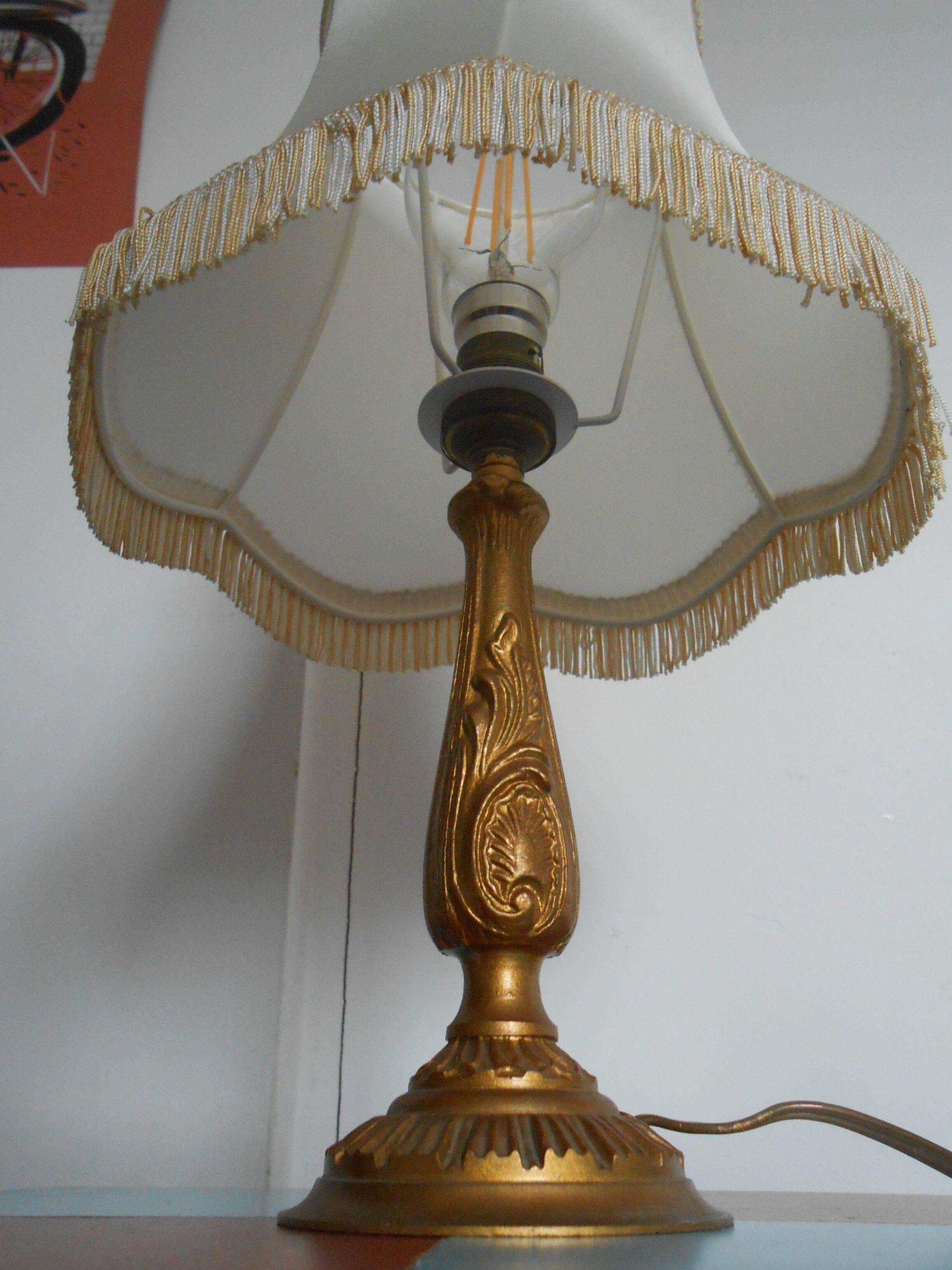 Lamp with brass foot and fringed lampshade