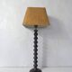 turned wooden lamp with spool base and vintage copper shade