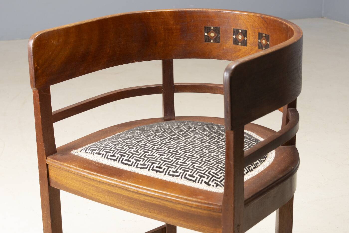 Central European armchair from the early 20th century with an inlaid backrest.