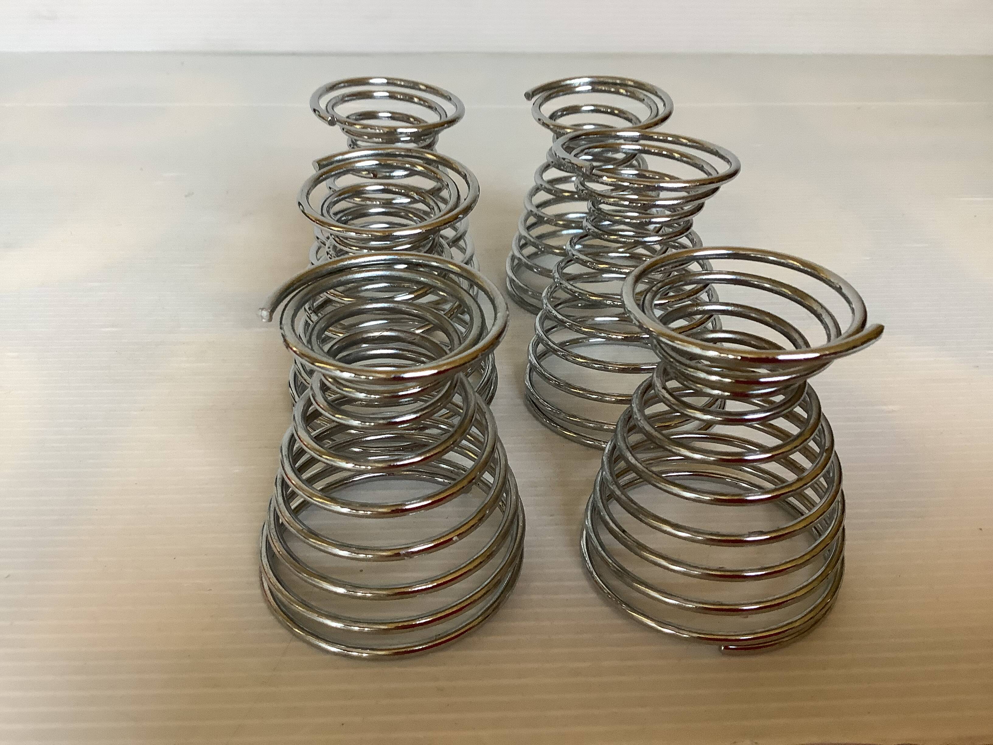 Six metal spiral egg cups