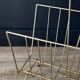 Mid-century magazine rack in golden metal wire