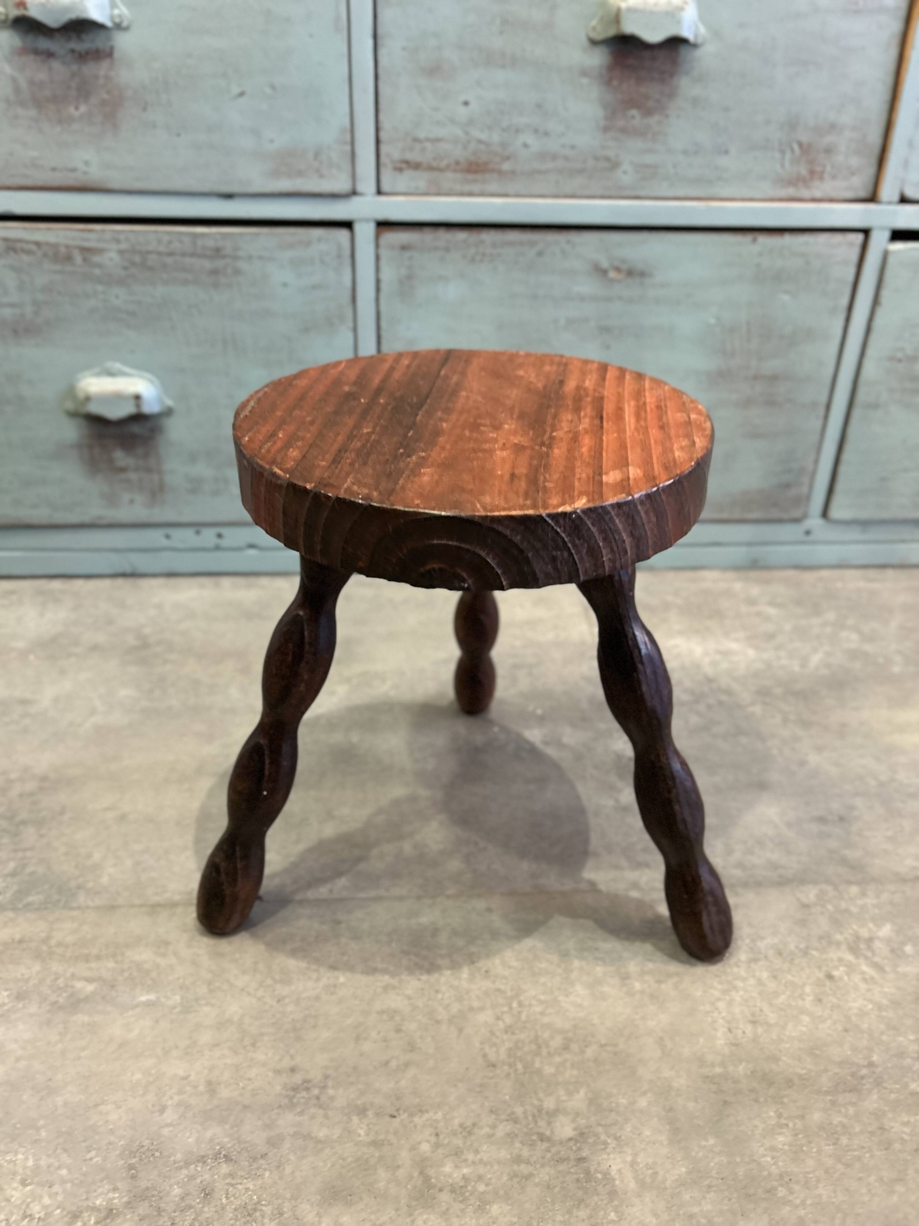 Three-legged stool with beaded wooden legs