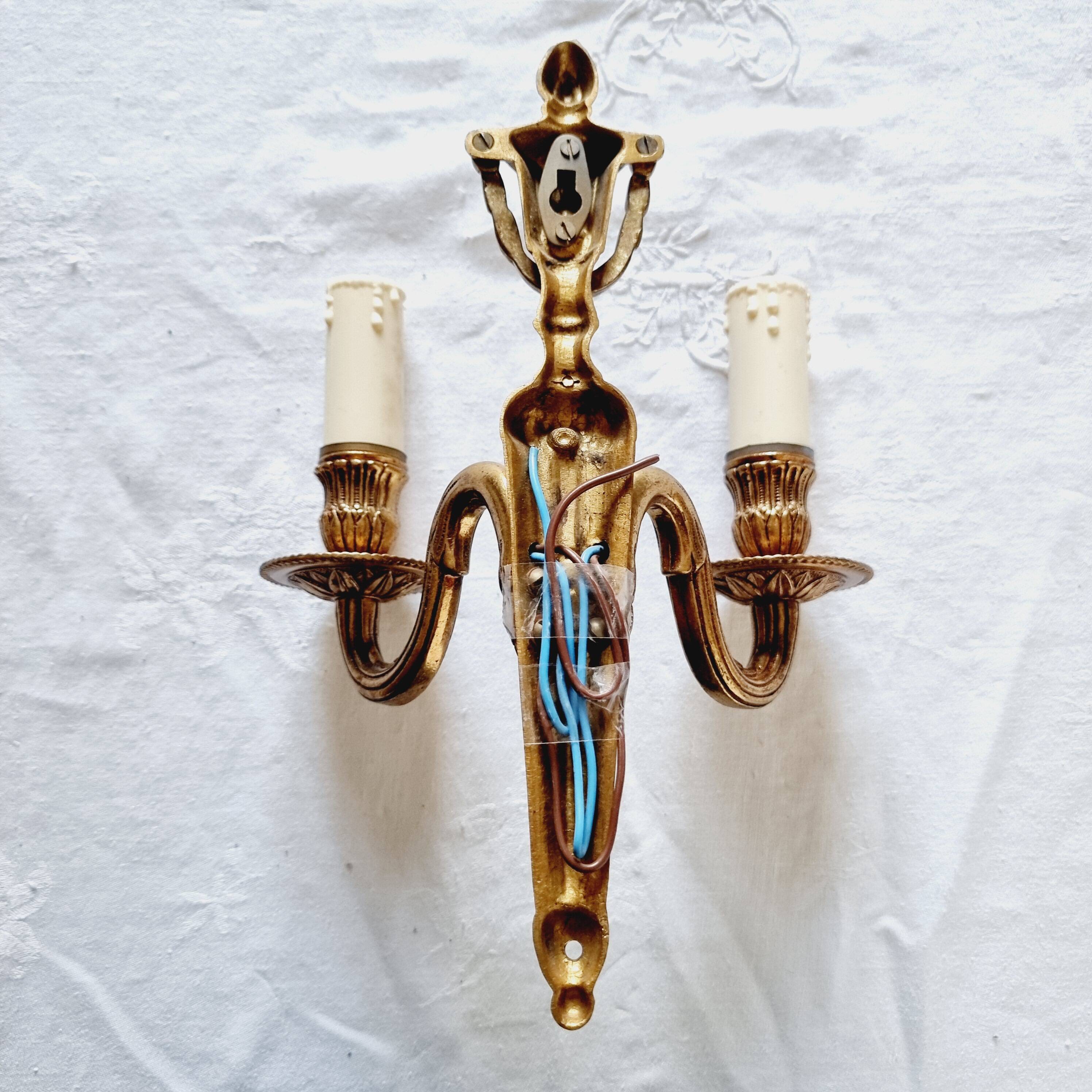 French Empire-style wall sconce or chandelier in bronze with an antique gold patina.