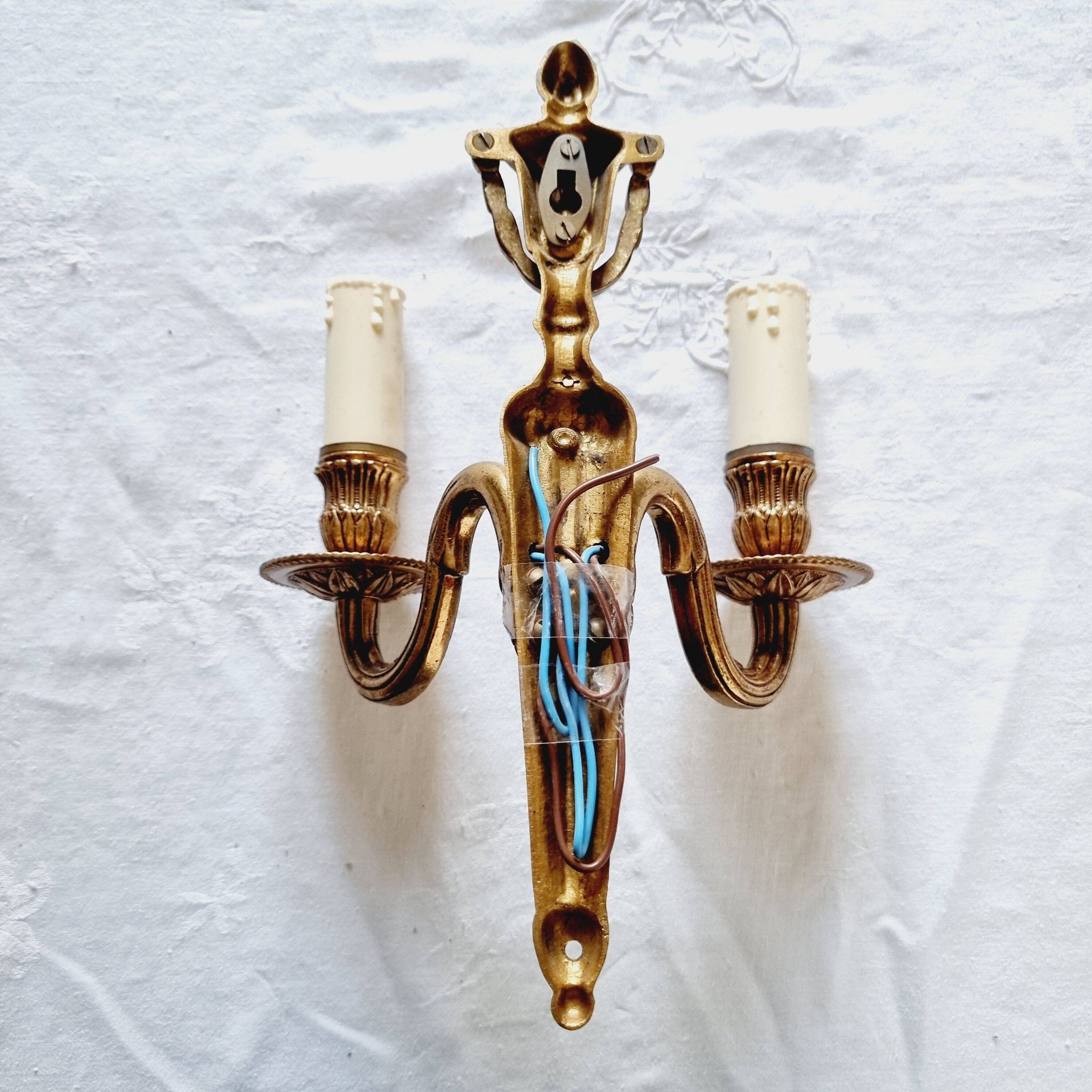 French Empire-style wall sconce or chandelier in bronze with an antique gold patina.