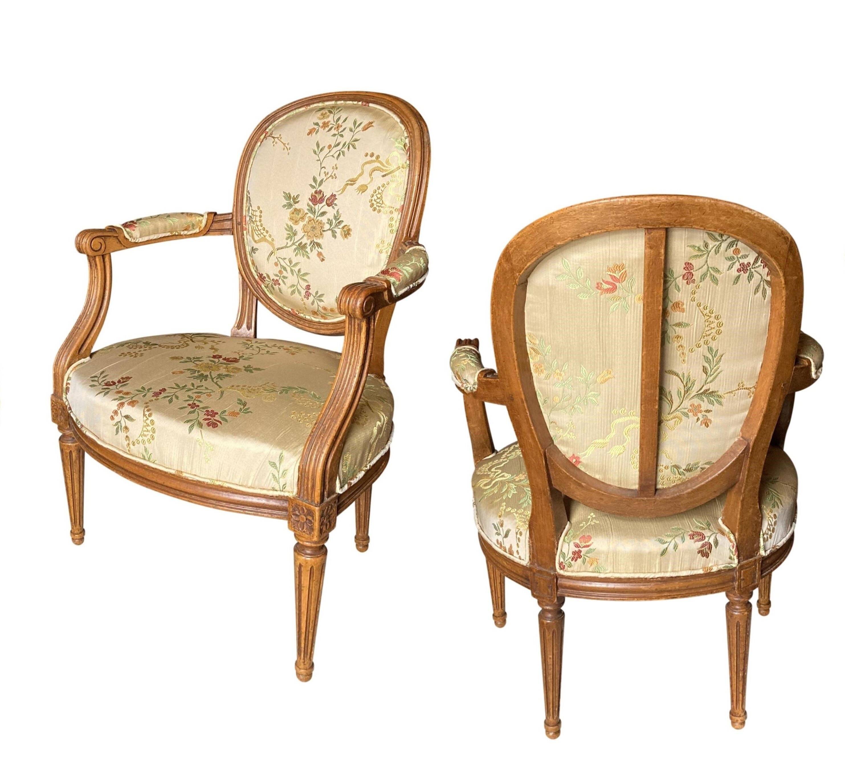 Pair of Louis XVI silk cabriolet armchairs