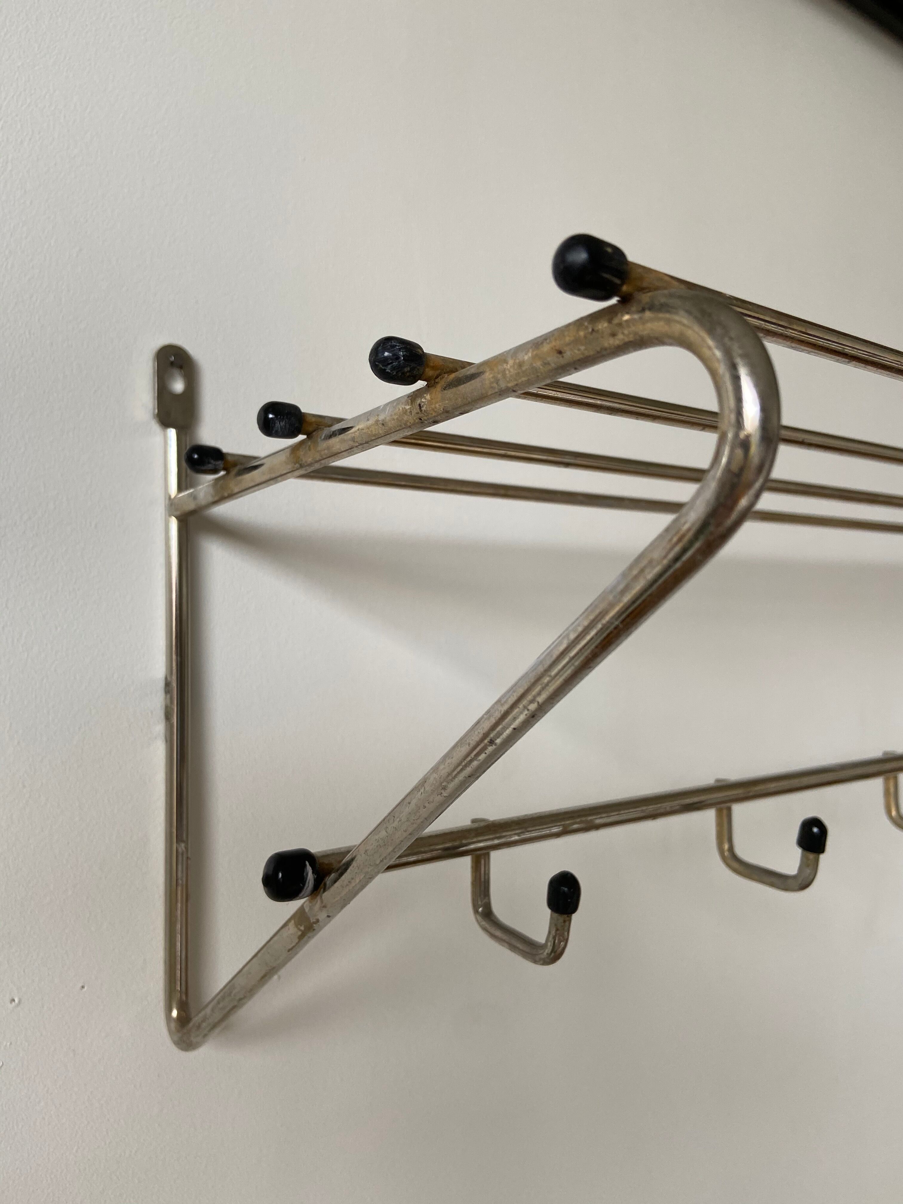 Metal wall coat holder with tablet