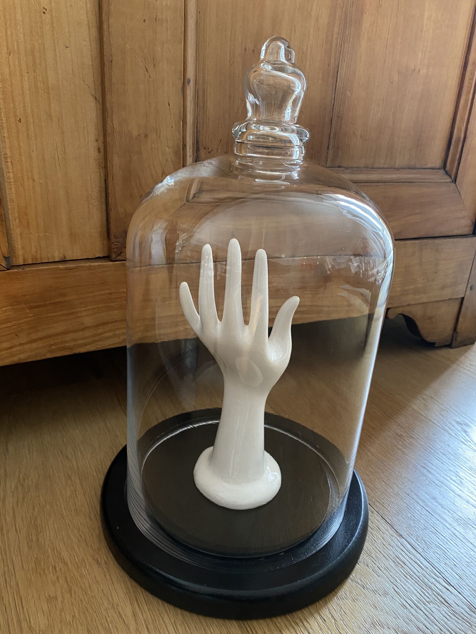 Large old glass bell and its wooden base