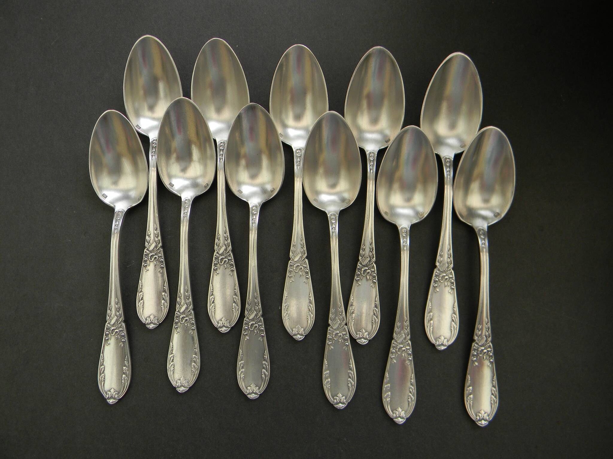 Set of 11 SFAM silver metal teaspoons.