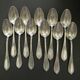 Set of 11 SFAM silver metal teaspoons.