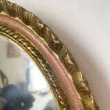 Oval Florentine mirror in powder pink and gold wood, 1960s.