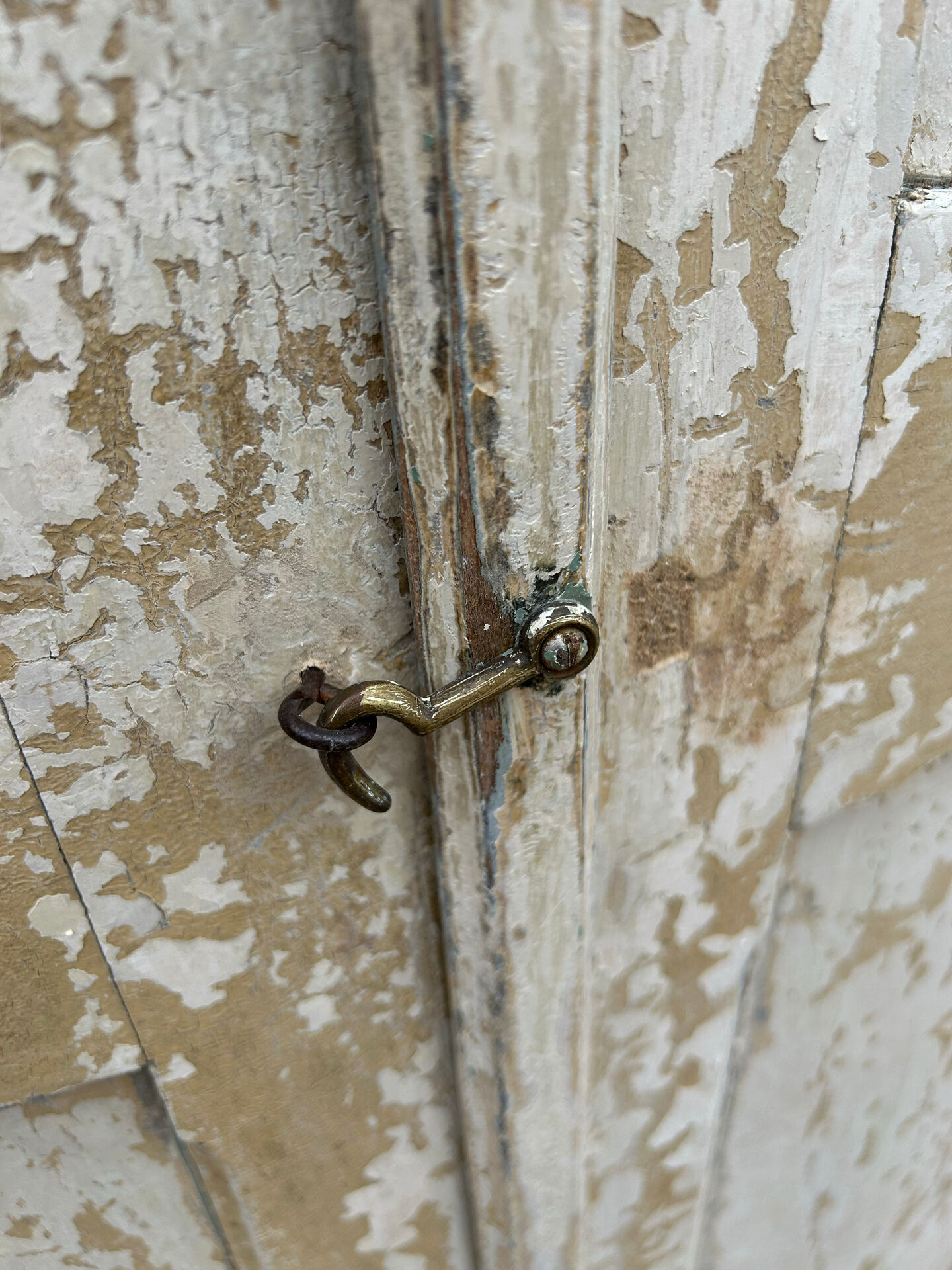 Small antique wardrobe with a faded white patina.