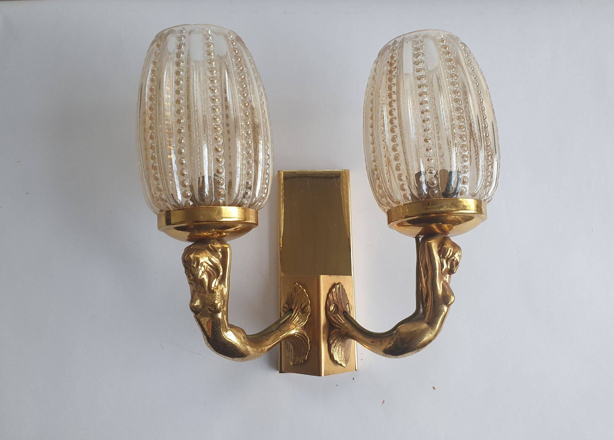 Golden bronze wall lamp with mermaids for an old bathroom.