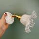 Vintage tulip glass wall light in transparent, slightly pearlescent white.