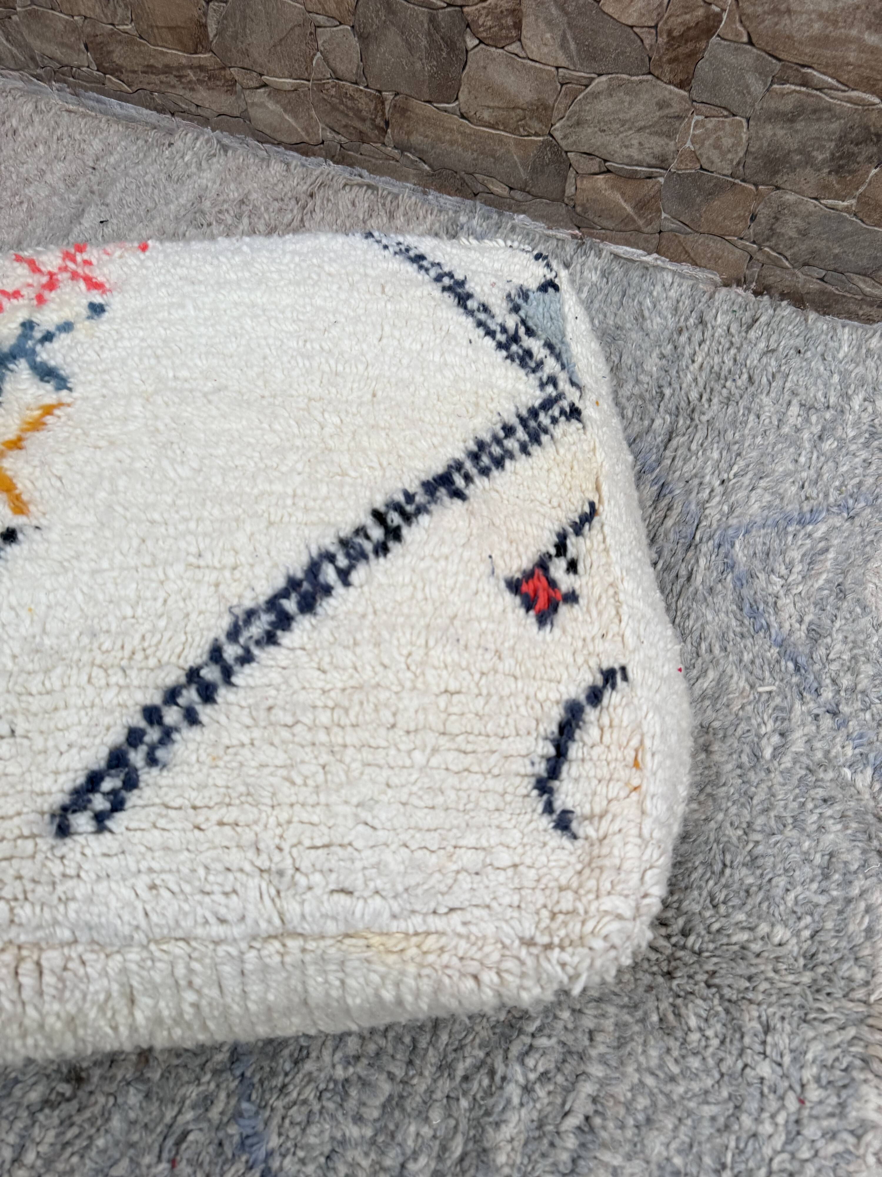 Berber floor pouf: Handwoven Moroccan wool cushion.