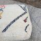 Berber floor pouf: Handwoven Moroccan wool cushion.