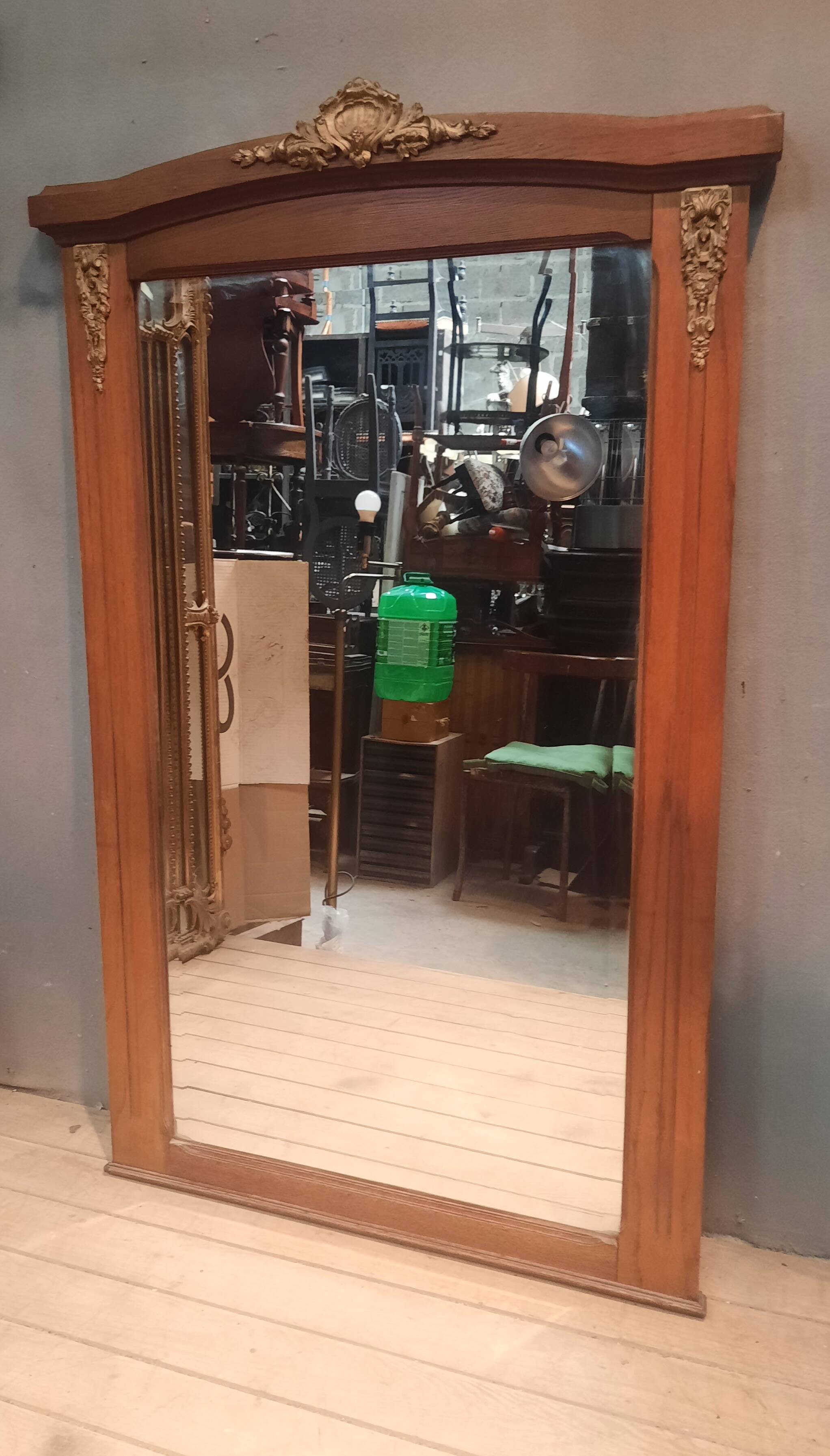 Bevelled mirror surrounded by a wooden frame.