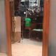 Bevelled mirror surrounded by a wooden frame.