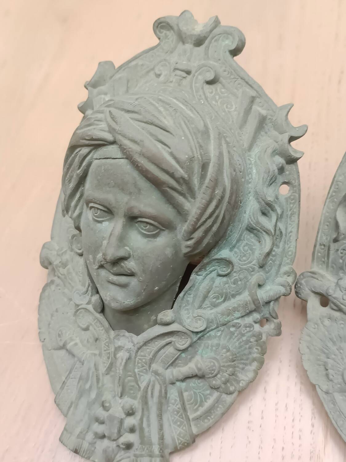 Bronze door knockers and billiard table corners