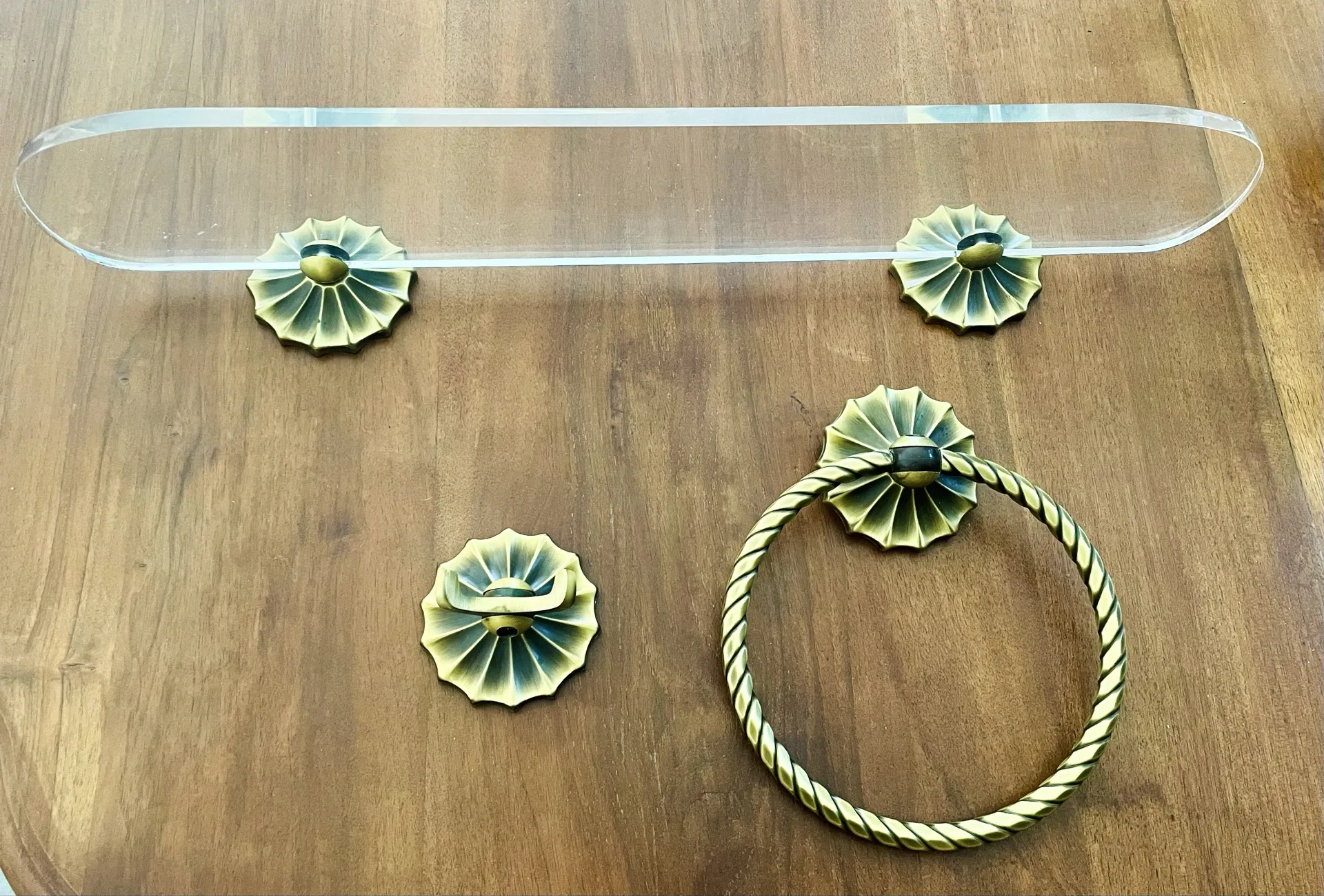 Vintage lucite and brass shelf with its hooks.