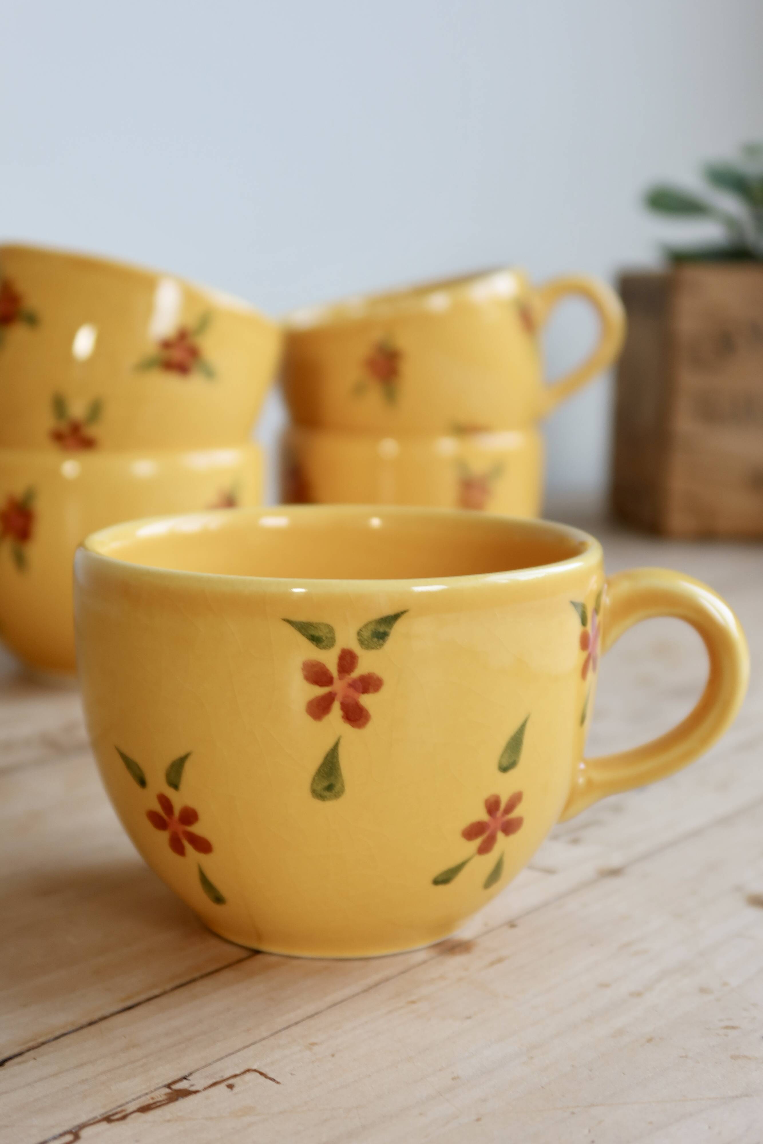 Large vintage ceramic mug in yellow with hand-painted flowers.