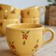 Large vintage ceramic mug in yellow with hand-painted flowers.