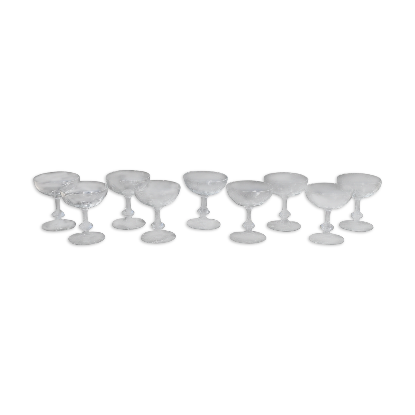 9 old champagne glasses in flat-waisted blown glass