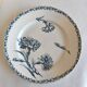 Two ironstone plates from Lunéville Keller and Guérin with a floral pattern.